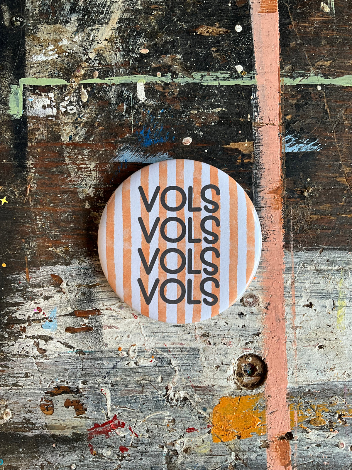 "VOLS" orange/white stripe background button