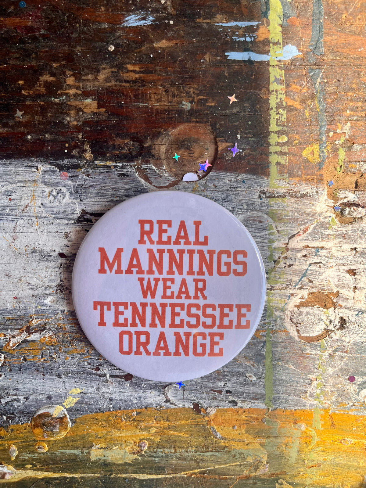 "REAL MANNINGS WEAR TENNESSEE ORANGE" orange letters on white button