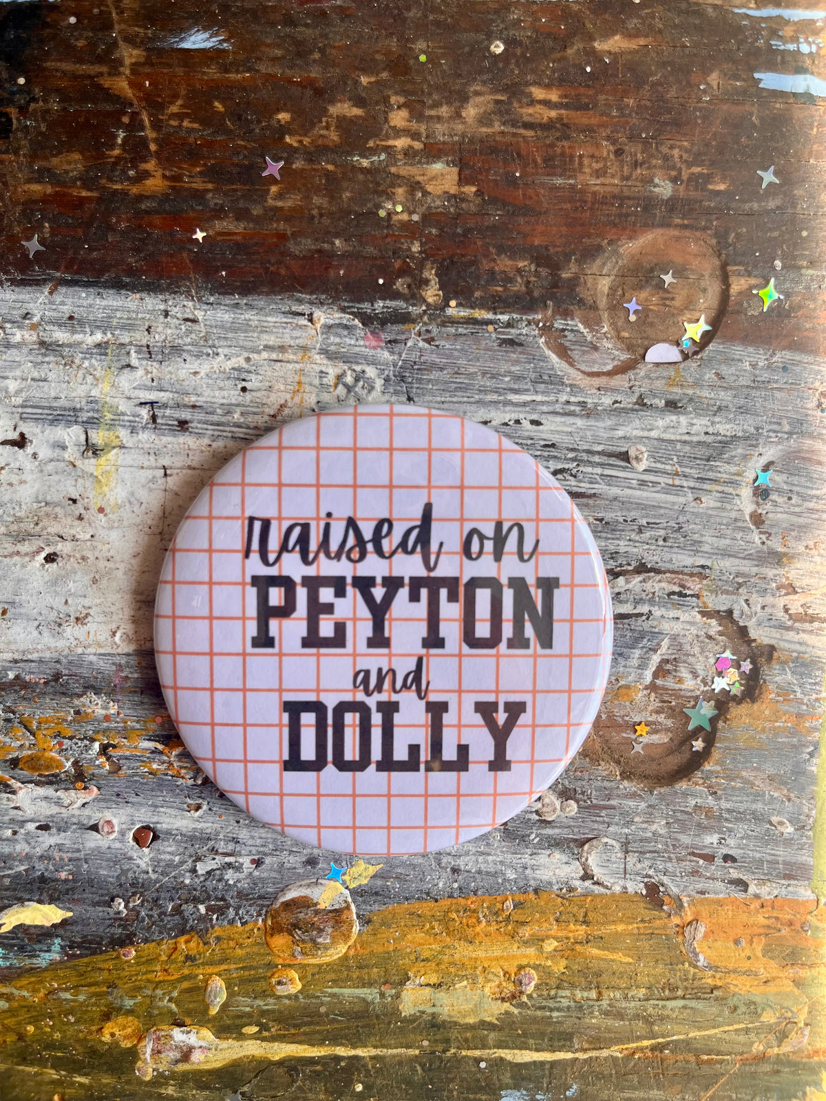 "raised on PEYTON and DOLLY" orange grid button